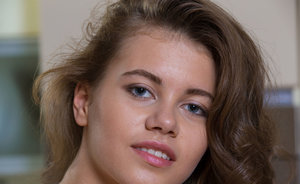 18 year old girl Agnes uncovers her perky tits as she gets completely naked